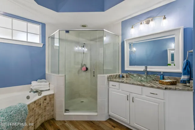 a bedroom with two beds and painting on the wall