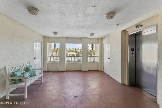 a view of a room with wooden floor and furniture