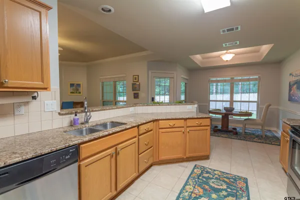 a kitchen with stainless steel appliances granite countertop a refrigerator stove and microwave