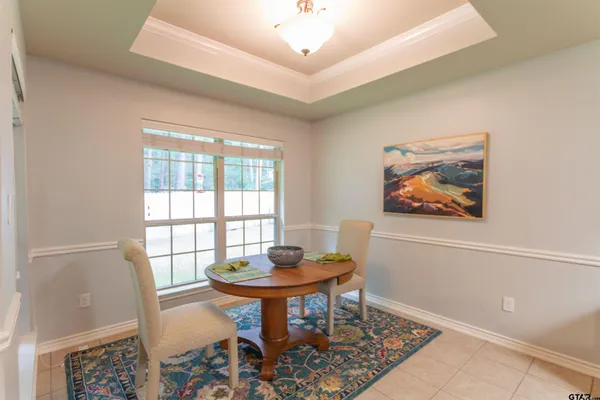 a living room with furniture a flat screen tv and a table