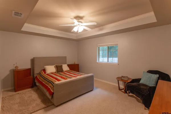a living room with furniture and a ceiling fan