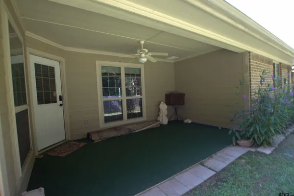 a backyard of a house with table and chairs