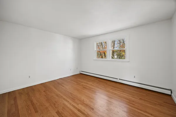 an empty room with a painting on the wall