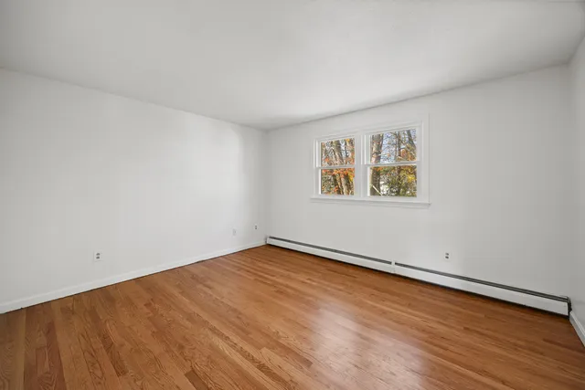 an empty room with a painting on the wall