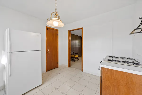 a kitchen with stainless steel appliances granite countertop a refrigerator a stove and a sink