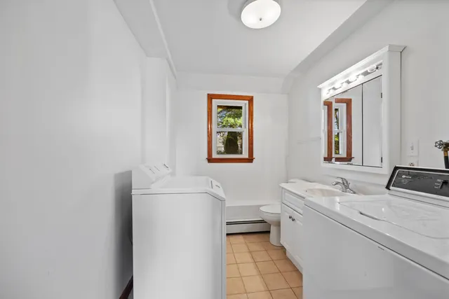 a bathroom with a sink a toilet and mirror