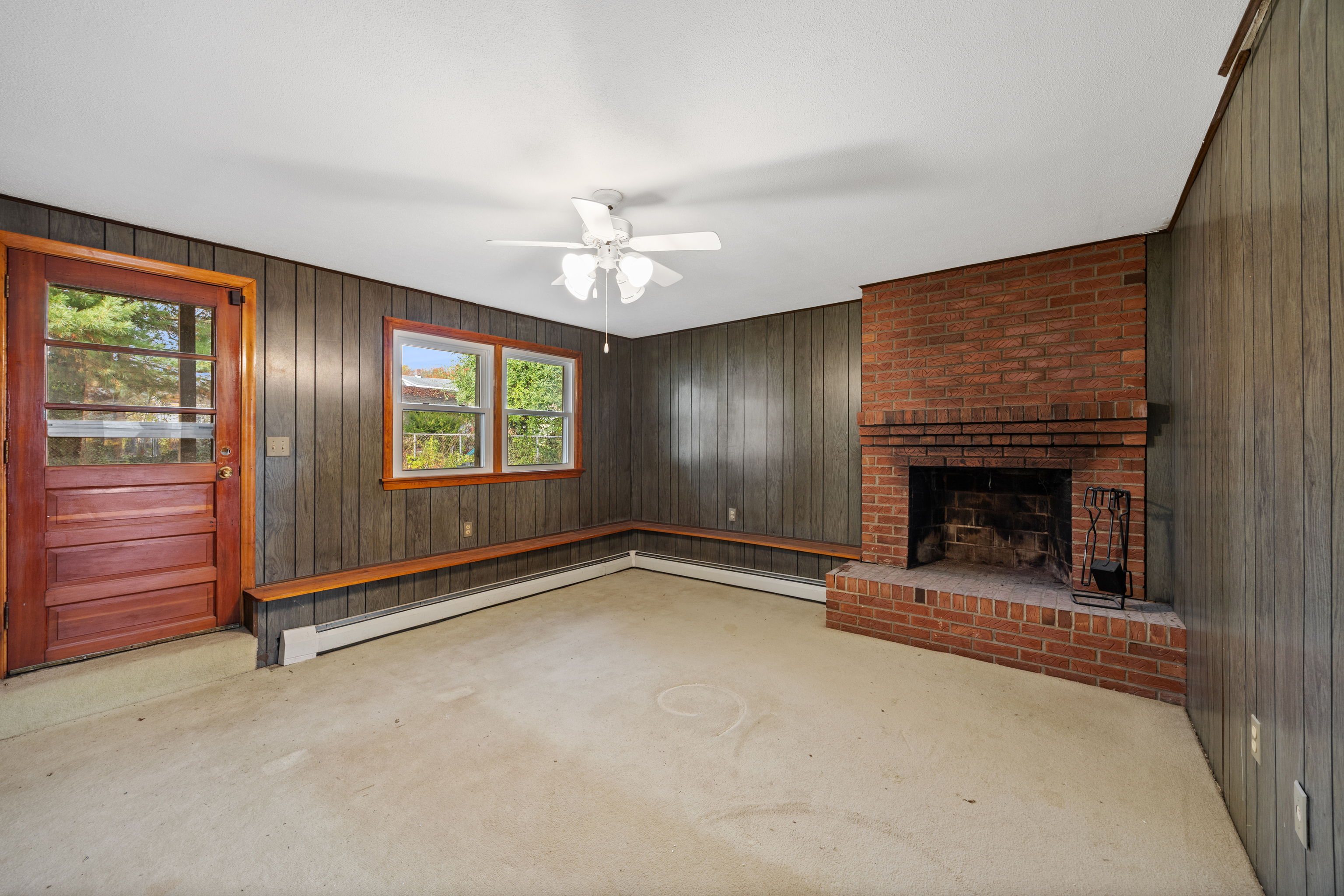 19 Albert Avenue Wethersfield, CT 06109 - Photo 26 of 32 an empty room with windows cabinet and fireplace
