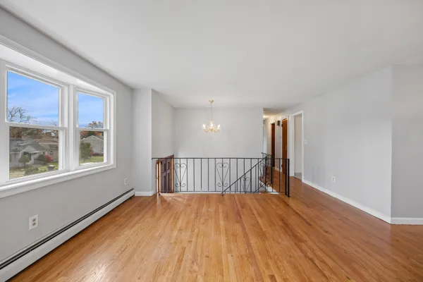 a view of a room with wooden floor and windows