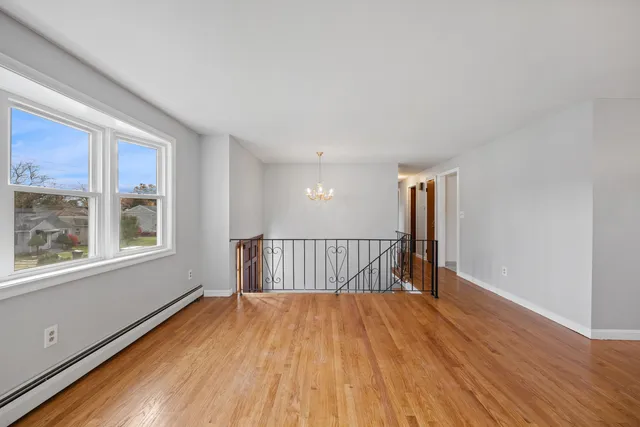 a view of a room with wooden floor and windows