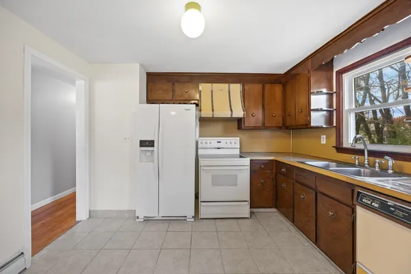 a kitchen with a refrigerator sink and cabinets