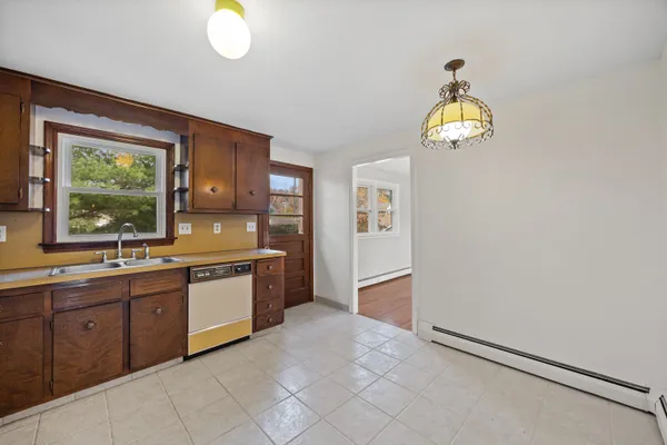 a large kitchen with granite countertop a stove a sink and a window