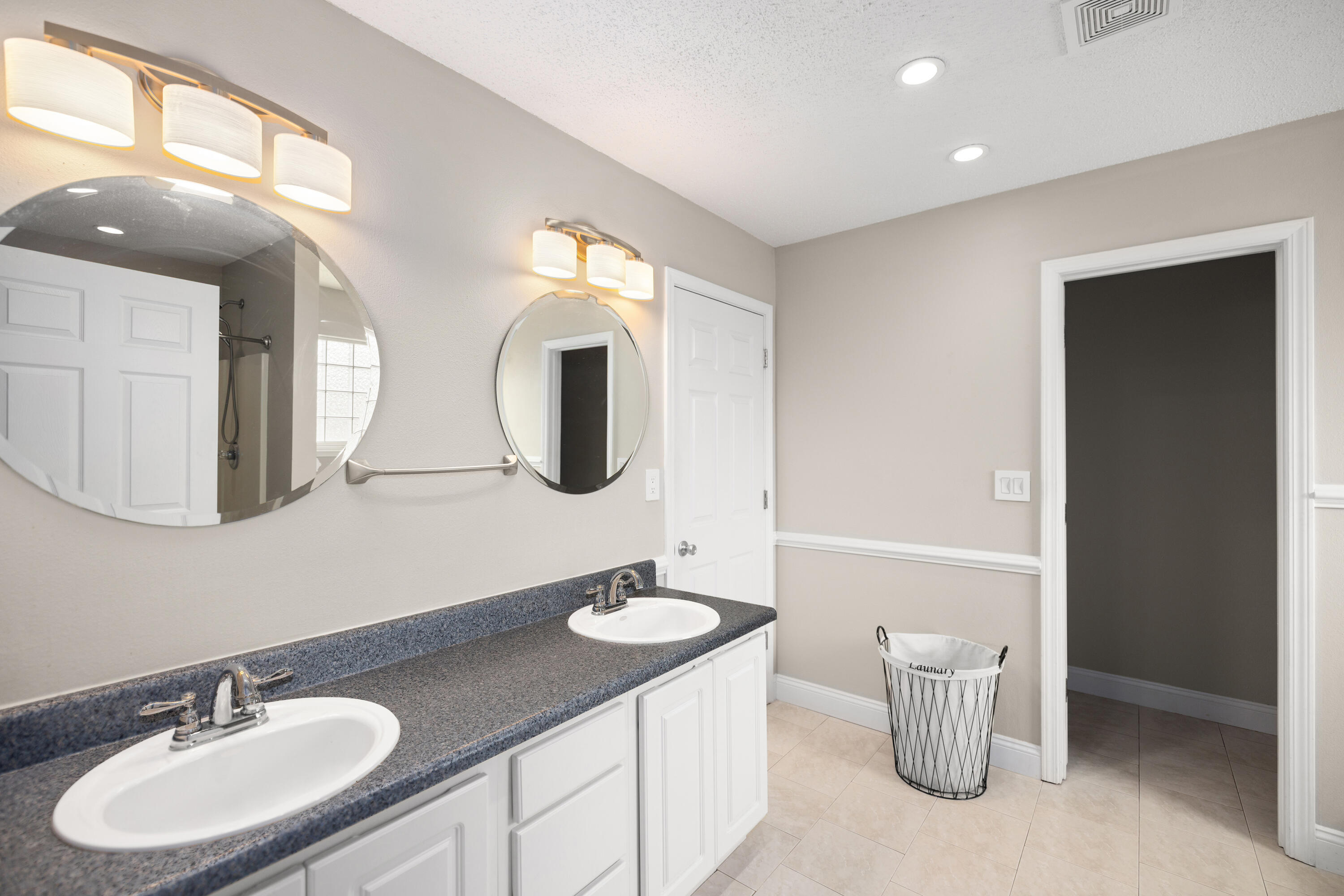 202 Limestone Circle Crestview, FL 32539 - Photo 22 of 49 a bathroom with a double vanity sink and a mirror