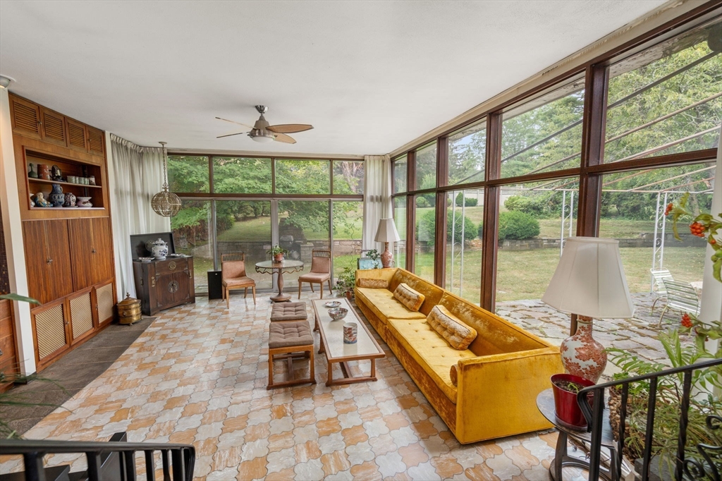 65 Lagrange Street Brookline, MA 02467 - Photo 1 of 39 a living room with furniture tv and large windows