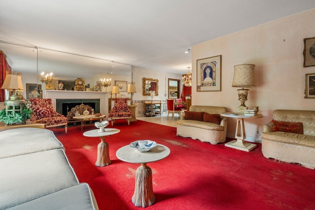 65 Lagrange Street Brookline, MA 02467 - Photo 2 of 39 a living room with furniture a rug and a fireplace