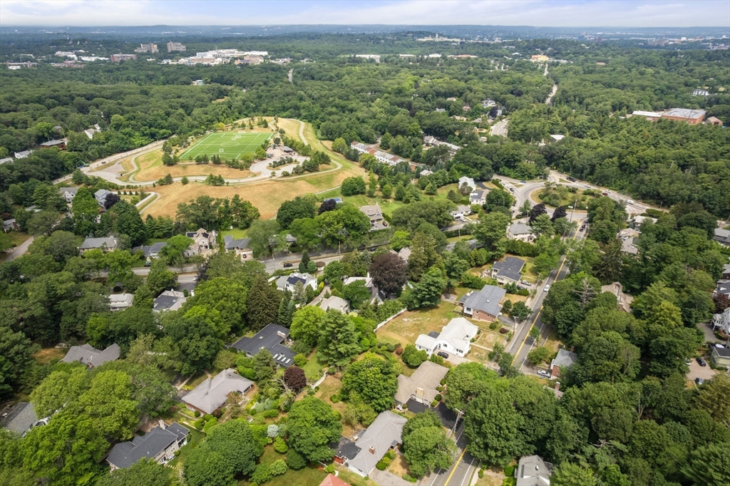 65 Lagrange Street Brookline, MA 02467 - Photo 25 of 39 an aerial view of a houses with a lush green hillside