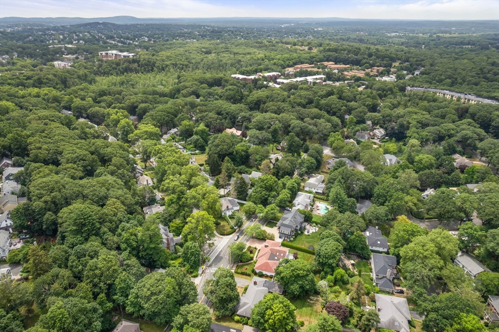 65 Lagrange Street Brookline, MA 02467 - Photo 31 of 39 an aerial view of a houses with a lush green hillside