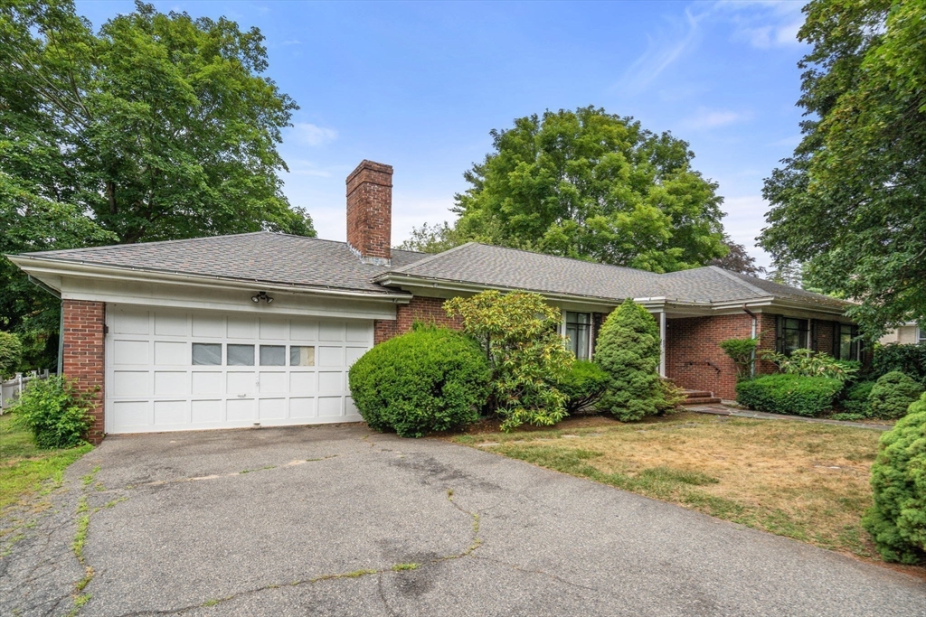 65 Lagrange Street Brookline, MA 02467 - Photo 5 of 39 a front view of a house with a yard and garage