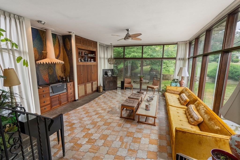 65 Lagrange Street Brookline, MA 02467 - Photo 9 of 39 a living room with furniture floor to ceiling window and a flat screen tv