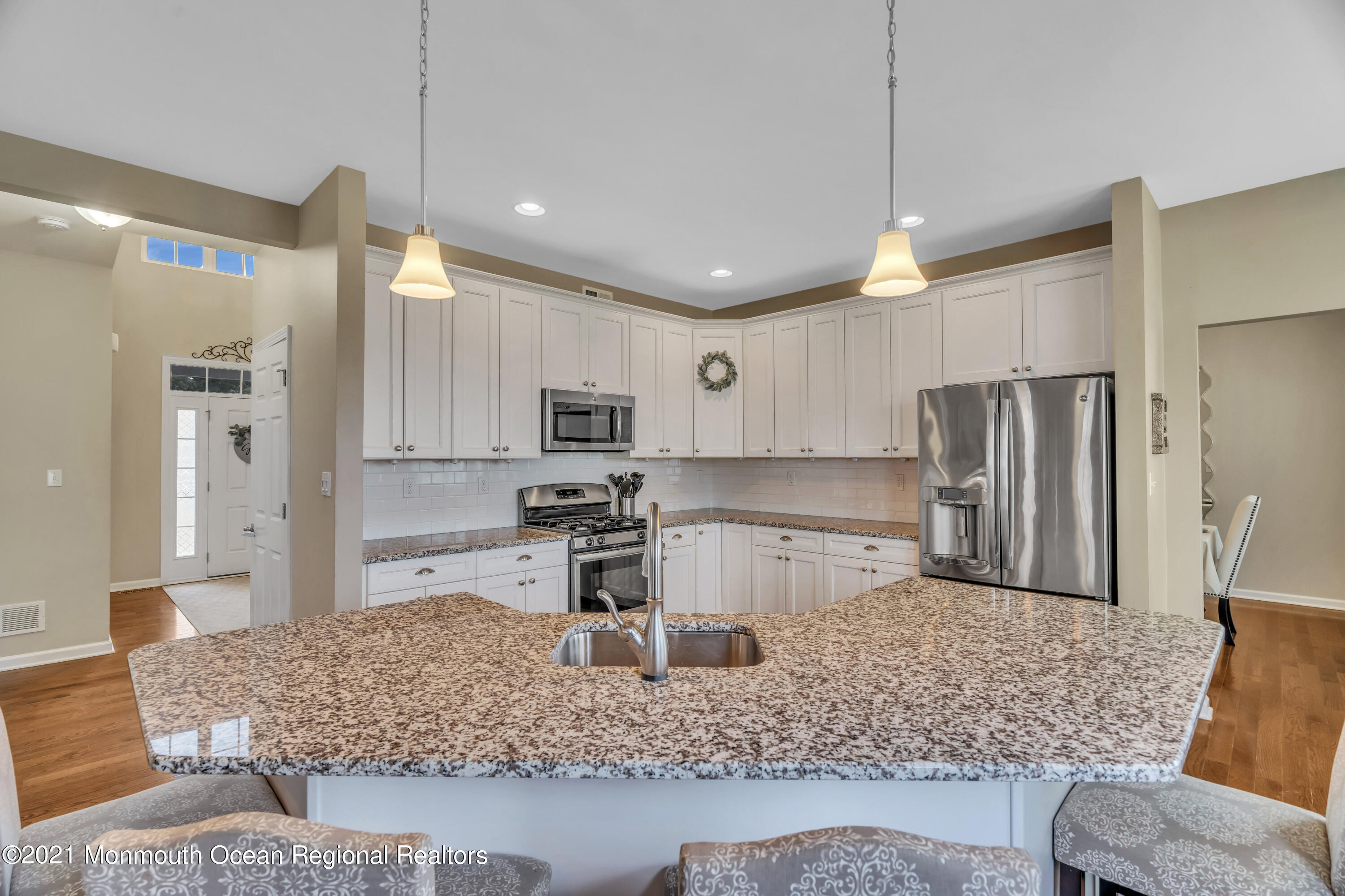 16 Bellagio Road Jackson, NJ 08527 - Photo 15 of 46 a large kitchen with stainless steel appliances kitchen island granite countertop a refrigerator and a sink