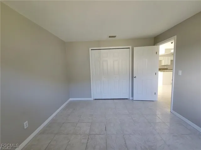 a view of an empty room and closet area