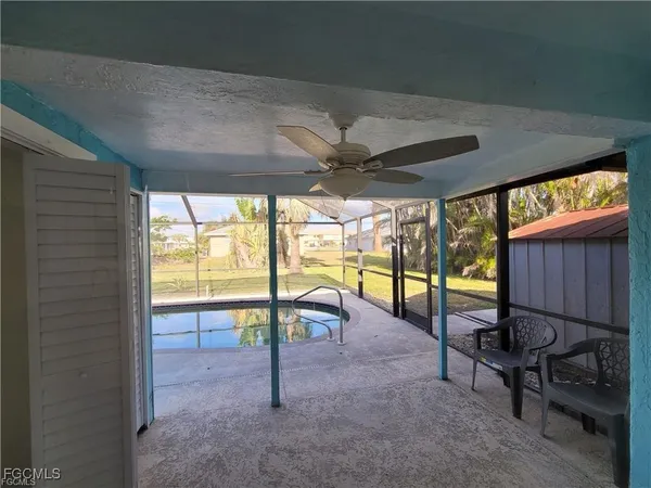 a view of a porch with chairs and backyard