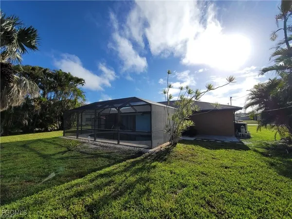 a view of a house with a yard and a garden