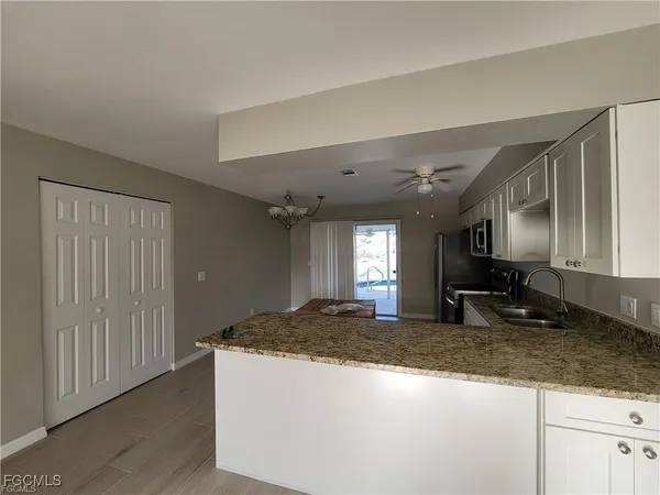 a view of a kitchen with granite countertop cabinets