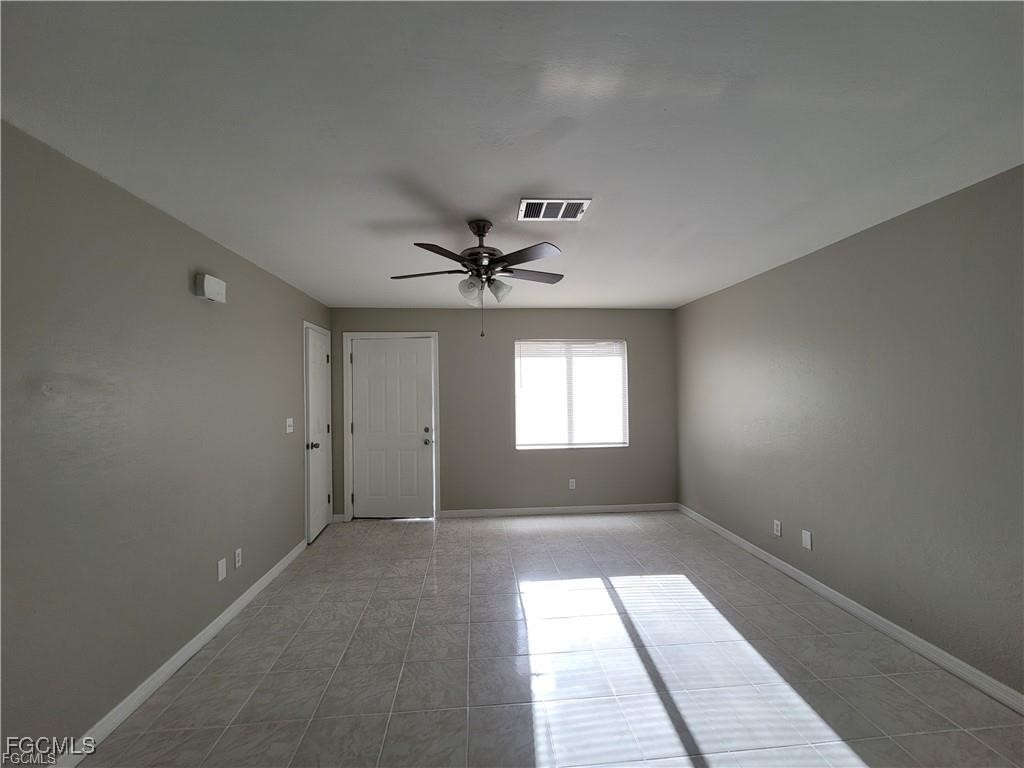 4530 Southwest 7th Place, Unit B Cape Coral, FL 33914 - Photo 5 of 18 an empty room with windows and fan
