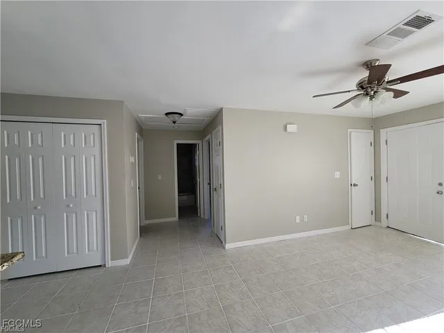 a view of an empty room with a ceiling fan