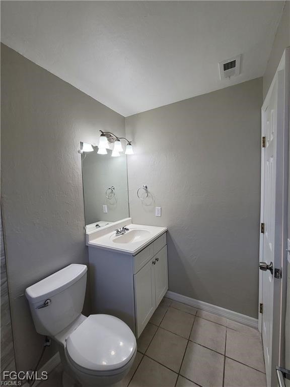 4530 Southwest 7th Place, Unit B Cape Coral, FL 33914 - Photo 8 of 18 a bathroom with a toilet sink and mirror