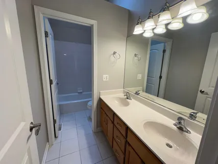 a spacious bathroom with a double vanity sink mirror and double
