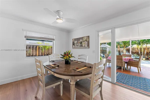 a view of a dining room with furniture and wooden floor