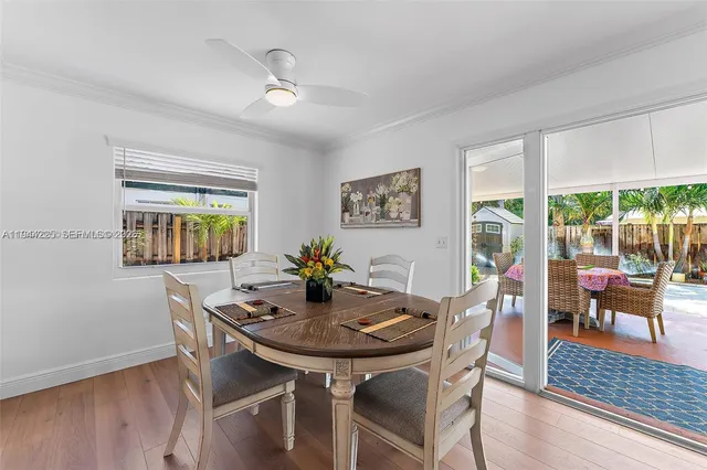 a view of a dining room with furniture and wooden floor