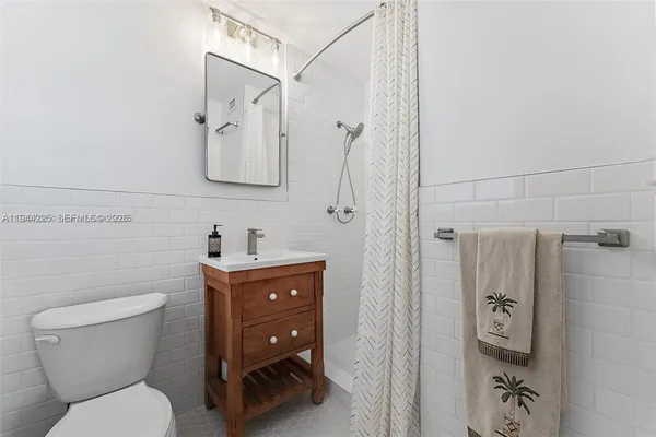 a bathroom with a toilet sink and a shower