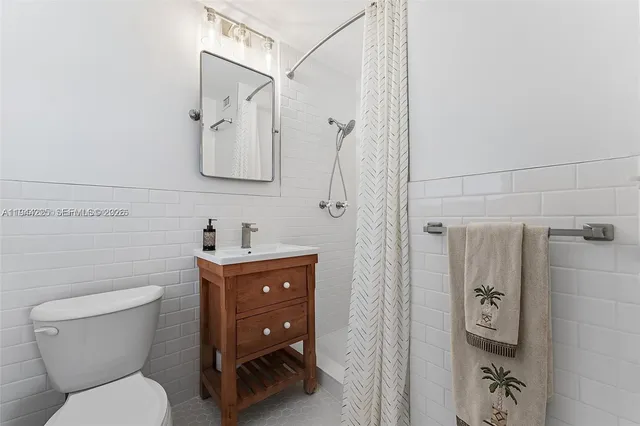 a bathroom with a toilet sink and a shower