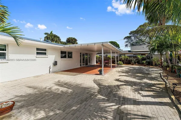 a house with palm tree in front of it