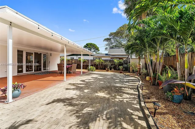 a view of a house with backyard and sitting area