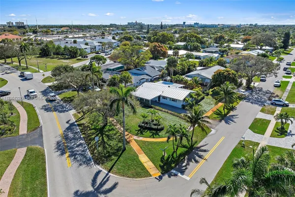 an aerial view of a house with a yard and lake view