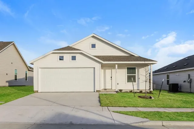 a front view of a house with a garden and plants
