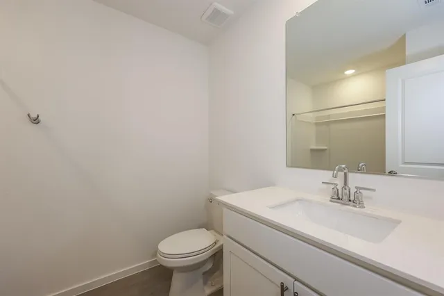 a bathroom with a sink toilet and a mirror