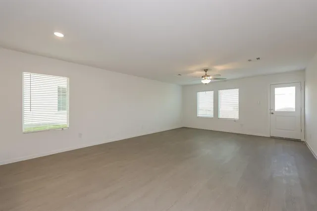 an empty room with windows and entrance