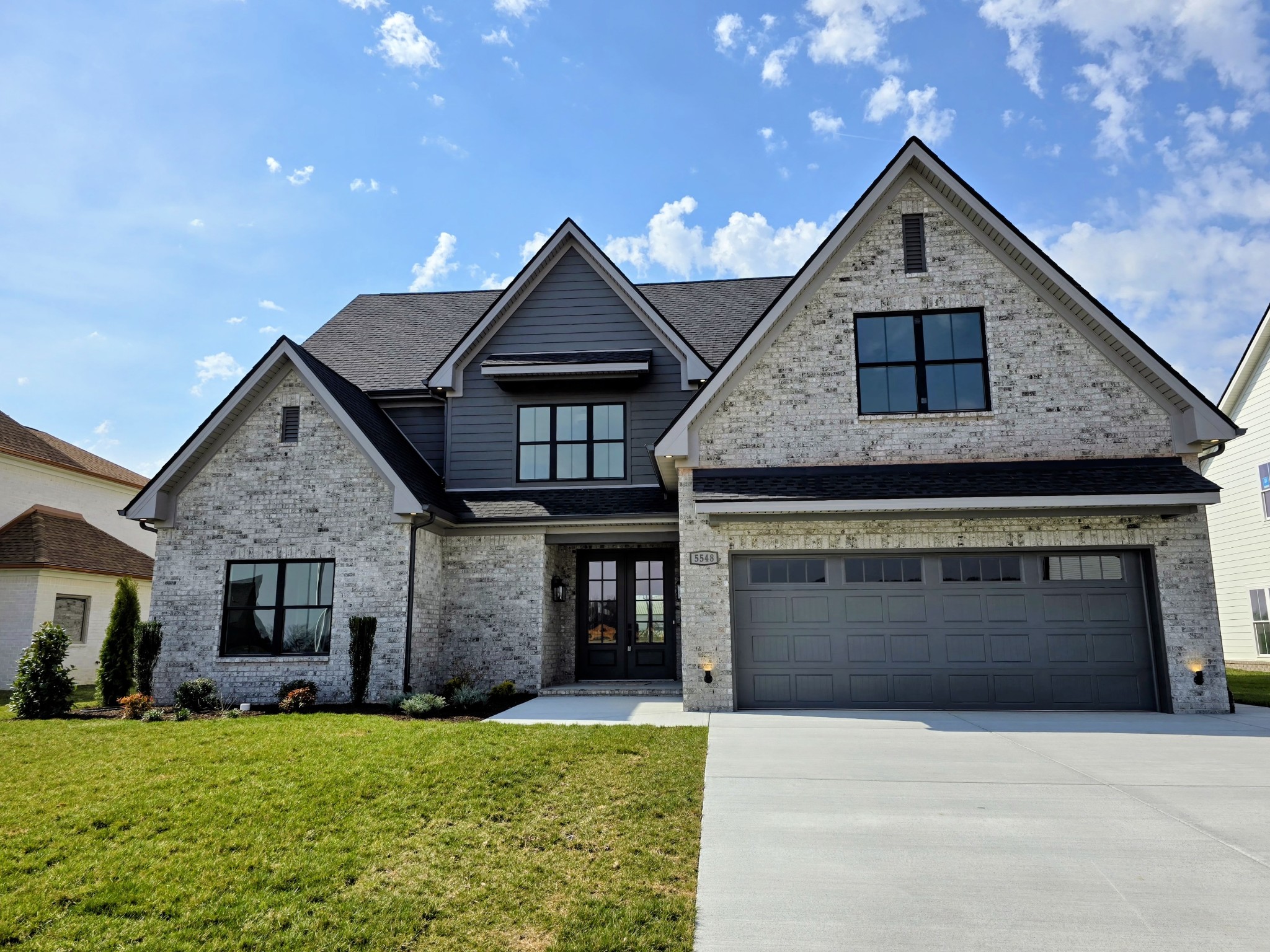 a front view of a house with a yard and garage