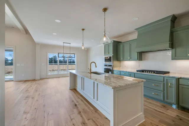 a front view of a house with a yard garden and trees