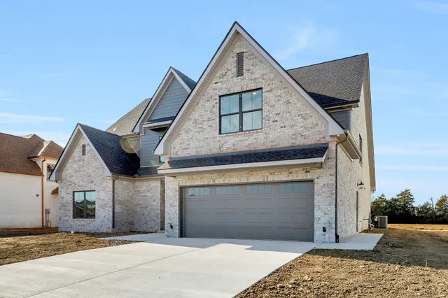 a front view of a house with a garage