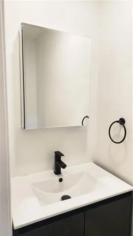 a white toilet sitting next to a white wall