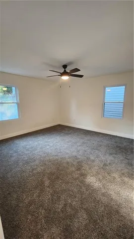 a bathroom with a toilet sink double vanity and mirror