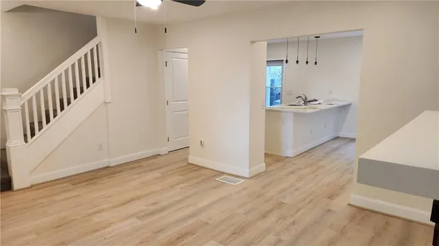 a view of a walk in closet and wooden floor