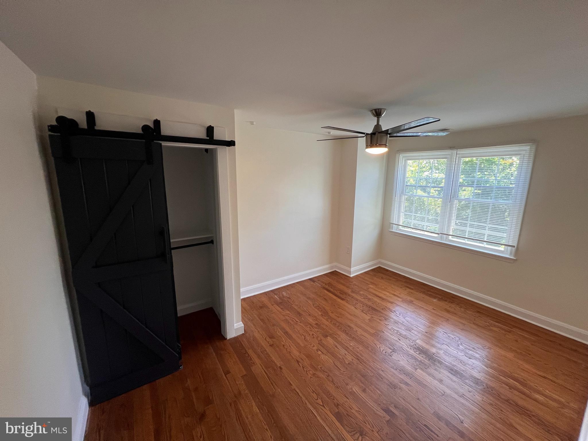 1583 Doxbury Road Towson, MD 21286 - Photo 11 of 31 a view of a livingroom with wooden floor and a ceiling fan