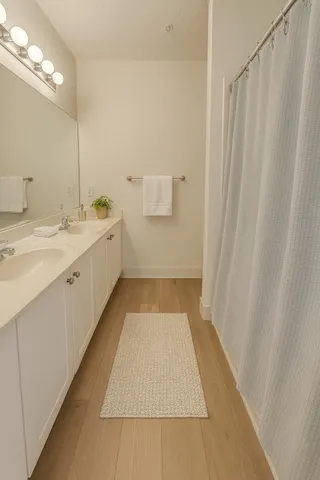 a bathroom with a sink a toilet and a mirror