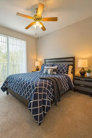 a bedroom with bed and window